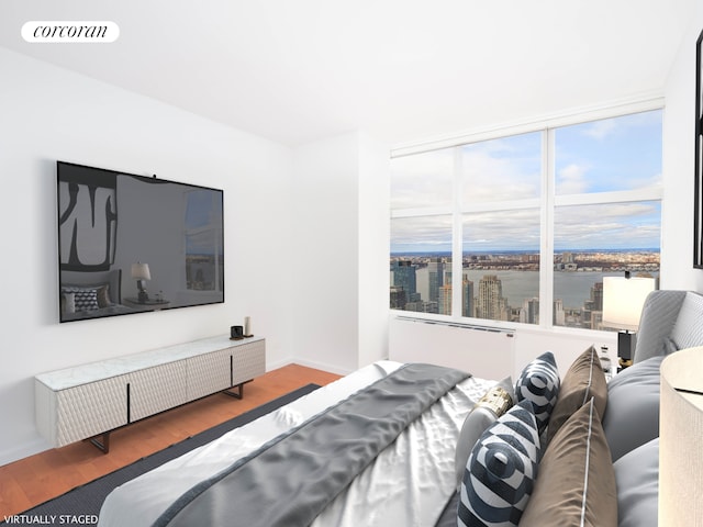 bedroom featuring wood finished floors, visible vents, and baseboards