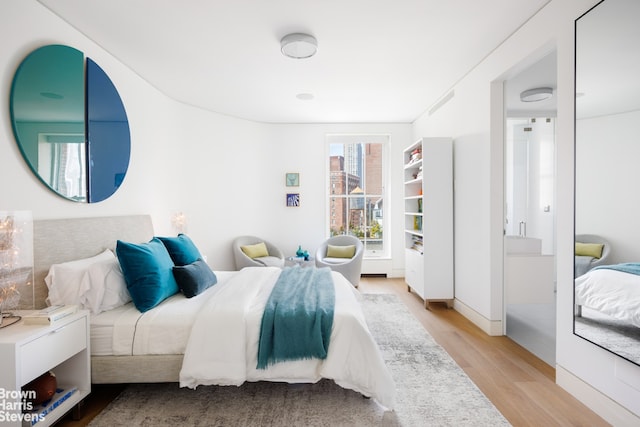 bedroom with light wood-style floors