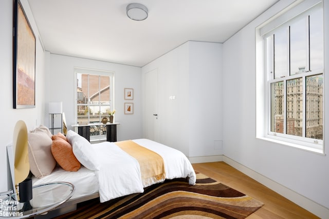 bedroom with baseboards and light wood-style floors