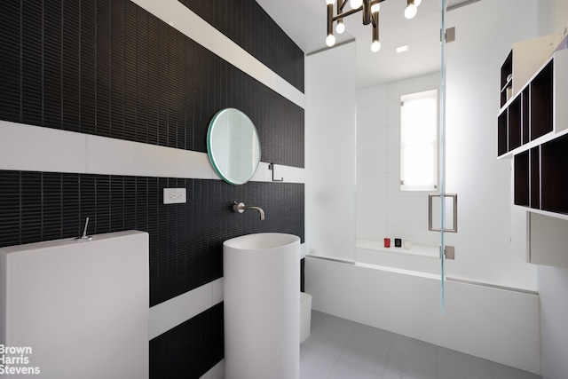 full bathroom with tile patterned floors, tile walls, and bathtub / shower combination