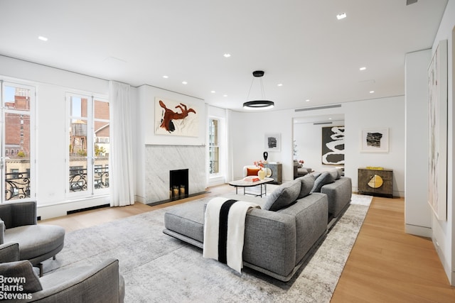 171 W 71st St Unit 9/10A, New York City, NY 10023 - living room featuring light wood-style flooring, recessed lighting, and a high end fireplace