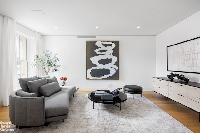 sitting room with recessed lighting, wood finished floors, and visible vents