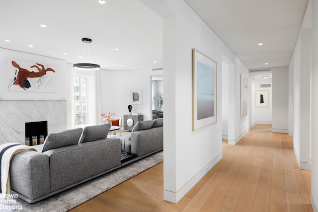 hall featuring recessed lighting, light wood-style flooring, and baseboards