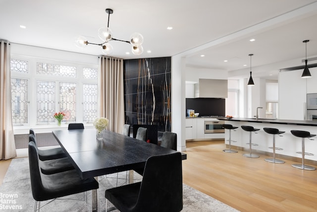 171 W 71st St Unit 9/10A, New York City, NY 10023 - dining area with light wood-type flooring, a chandelier, and recessed lighting