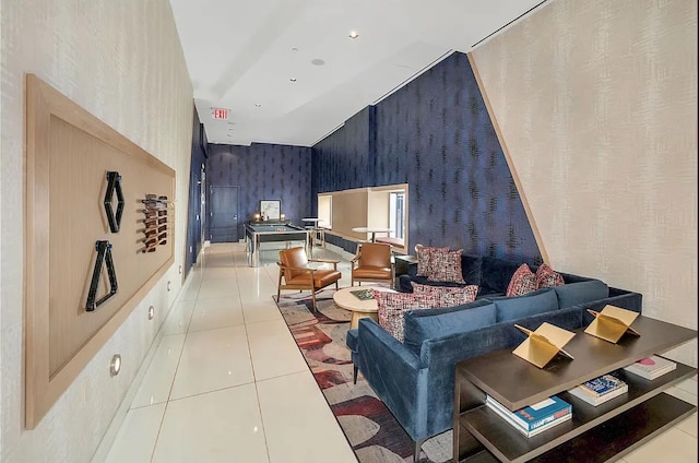 living area with tile patterned floors and wallpapered walls