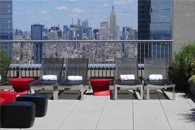view of patio / terrace featuring a skyline view and a balcony