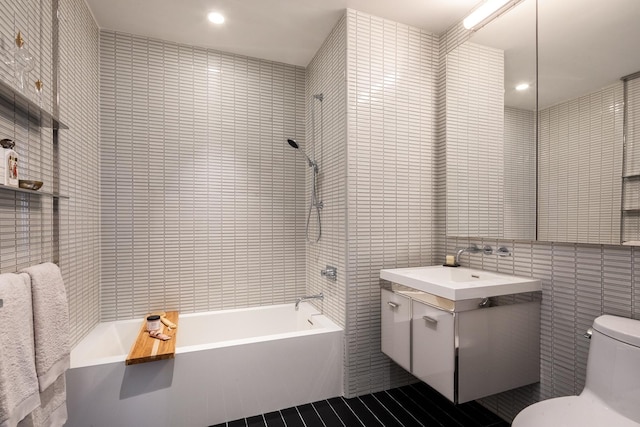 full bathroom featuring toilet, shower / bathtub combination, recessed lighting, tile walls, and vanity