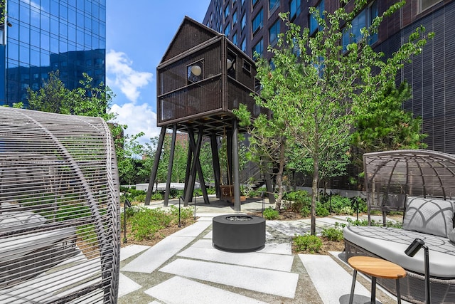 view of patio / terrace featuring a balcony and an outdoor fire pit