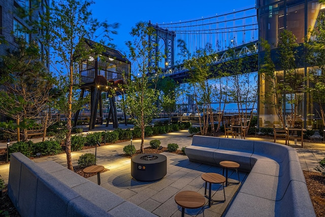 view of patio featuring playground community and an outdoor fire pit