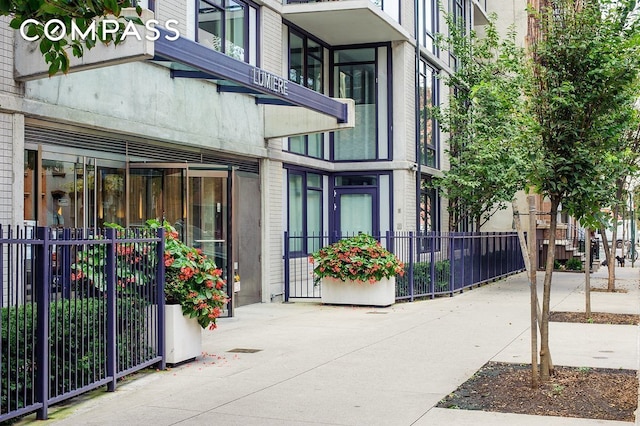 view of exterior entry with fence