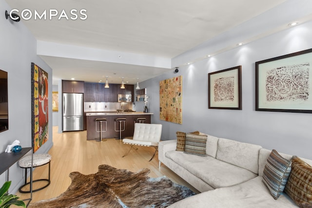 living area featuring recessed lighting and light wood finished floors