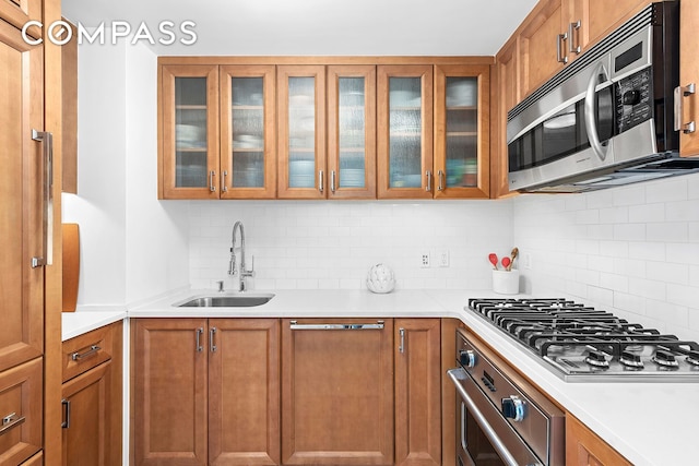 kitchen with a sink, brown cabinets, and appliances with stainless steel finishes