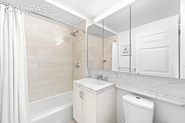 bathroom featuring backsplash, toilet, shower / bath combo with shower curtain, and vanity