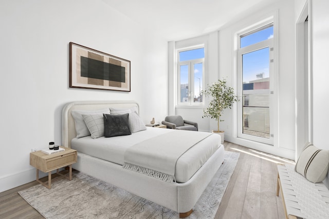 bedroom featuring wood finished floors and baseboards
