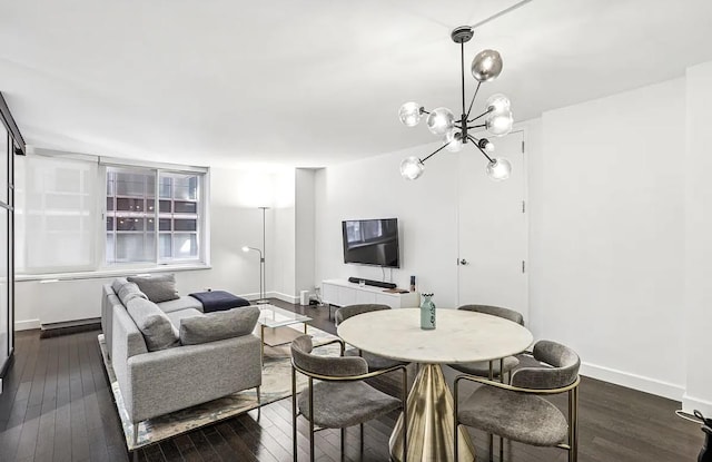 living area with a notable chandelier, baseboards, and dark wood-style flooring