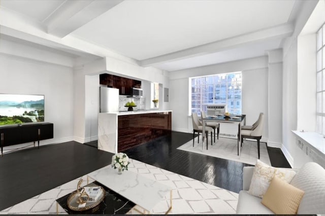 10 Park Ave Unit 11-K, New York City, NY 10016 - living room featuring wood finished floors, beam ceiling, and baseboards