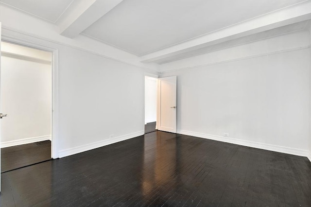 10 Park Ave Unit 11-K, New York City, NY 10016 - empty room with beamed ceiling, dark wood-style flooring, and baseboards