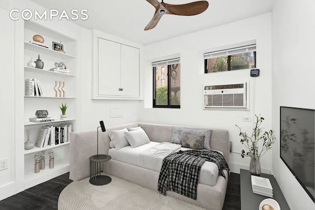 bedroom with an AC wall unit, ceiling fan, and dark wood-style flooring