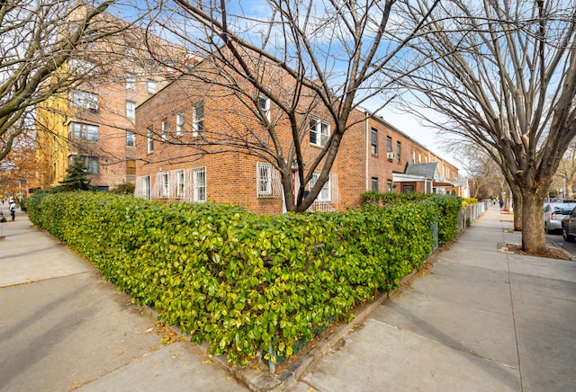 view of side of home featuring brick siding