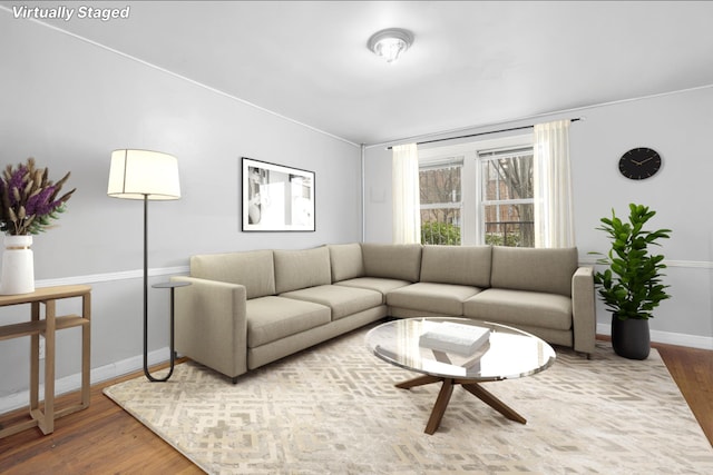 living area featuring baseboards and wood finished floors