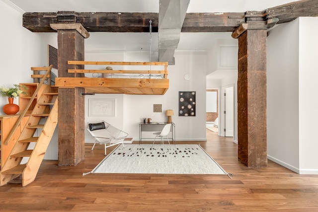 interior space featuring stairs, wood finished floors, and baseboards