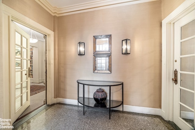 interior space with speckled floor, baseboards, and ornamental molding