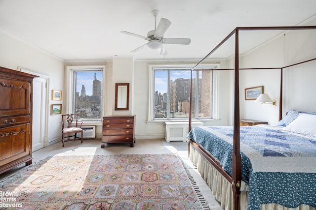 bedroom featuring a city view, ornamental molding, radiator heating unit, baseboards, and light colored carpet