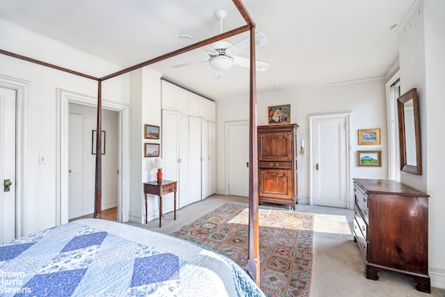 bedroom with crown molding, light colored carpet, a closet, and ceiling fan