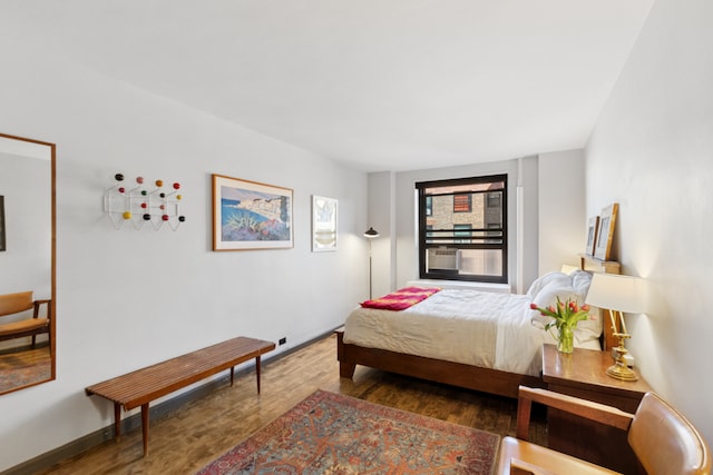 bedroom featuring wood finished floors and baseboards