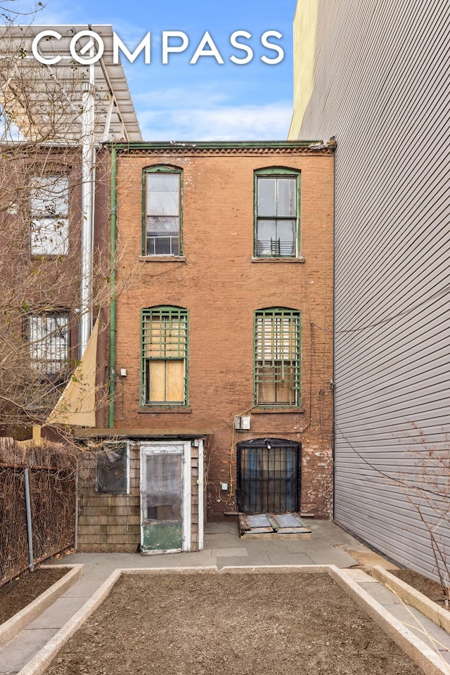 view of building exterior with fence