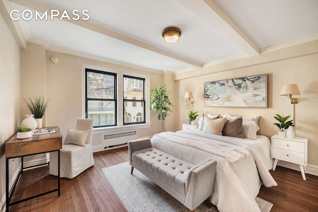 bedroom featuring beam ceiling, ornamental molding, hardwood / wood-style floors, radiator, and baseboards