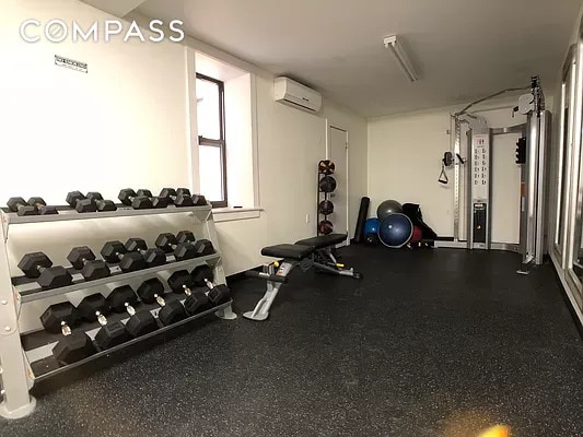 gym featuring an AC wall unit