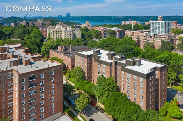 drone / aerial view featuring a view of city and a water view