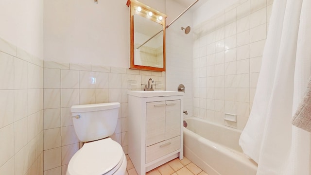 full bath featuring tile walls, shower / bath combination with curtain, toilet, vanity, and tile patterned floors