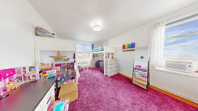 playroom featuring vaulted ceiling, baseboards, and cooling unit