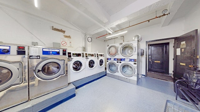 community laundry room with stacked washer and clothes dryer, tile patterned floors, and separate washer and dryer