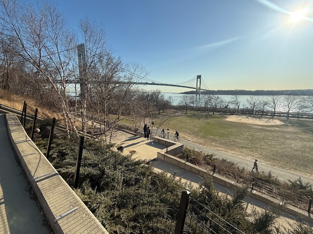view of yard with a water view and fence