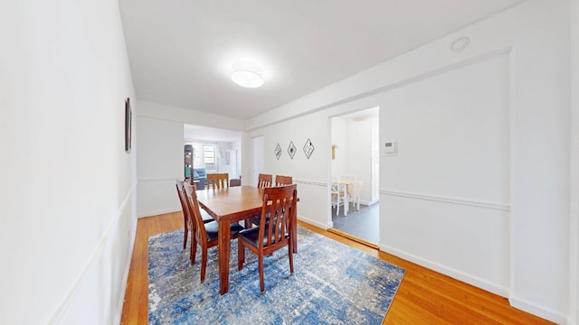 dining space with wood finished floors