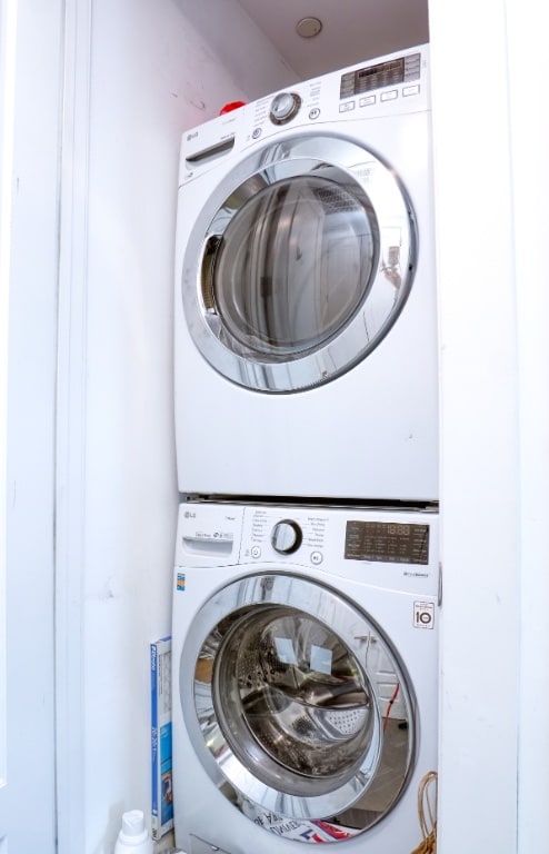 laundry area with laundry area and stacked washer and dryer