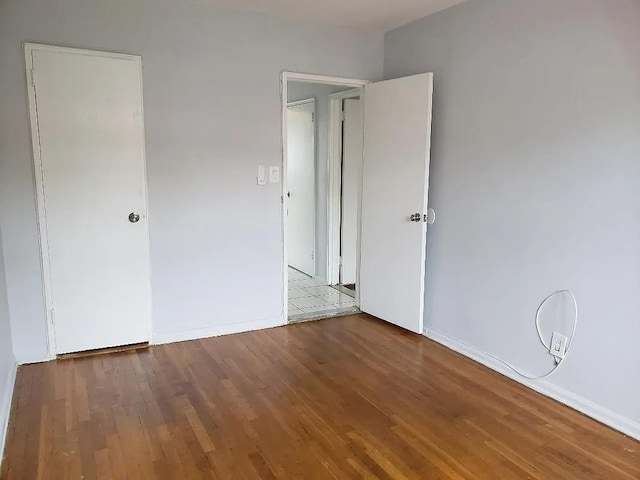 1207 E 83rd St, New York City, NY 11236 - unfurnished bedroom featuring wood finished floors and baseboards