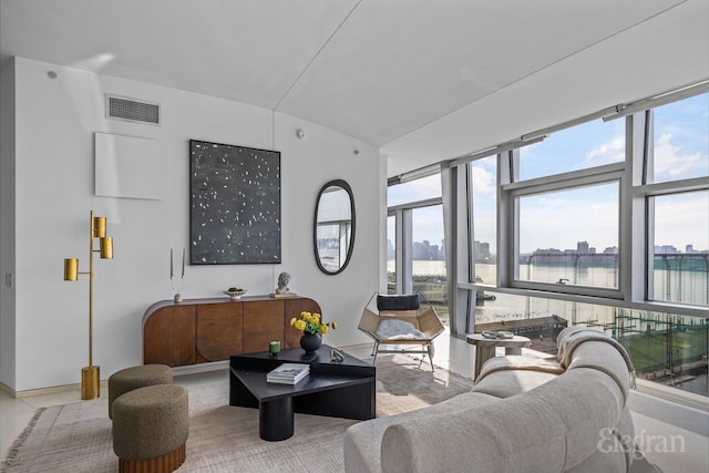 living area with a city view, plenty of natural light, and visible vents