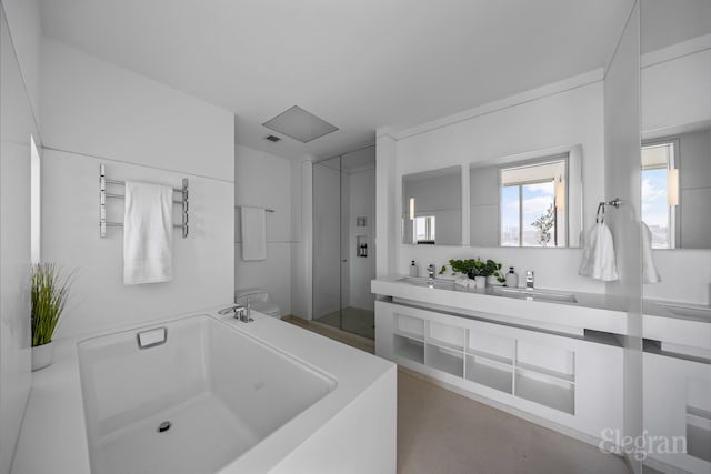 bathroom with a tub, finished concrete floors, toilet, double vanity, and a sink