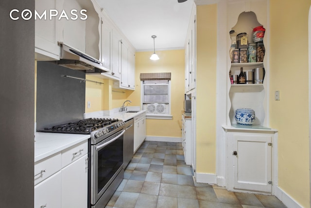 kitchen featuring baseboards, pendant lighting, white cabinets, stainless steel appliances, and a sink