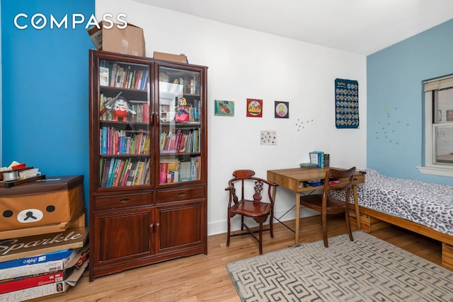 dining space with light wood-style flooring and baseboards