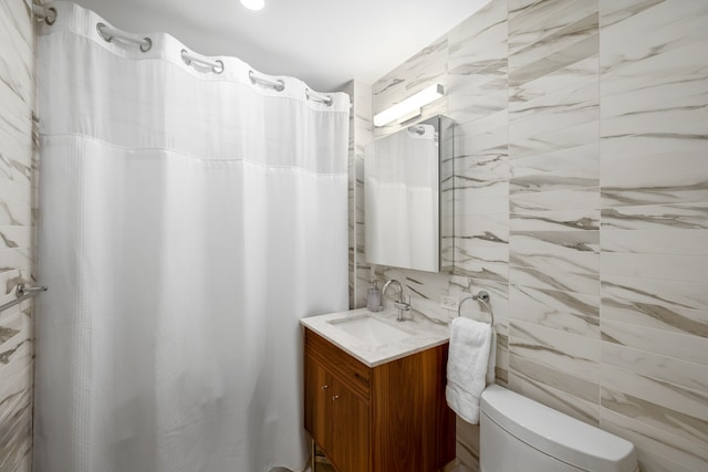 full bathroom with vanity, tile walls, curtained shower, and toilet