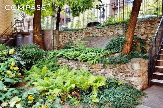 view of yard featuring stairs and fence