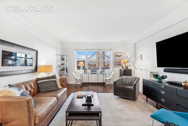 living area with baseboards and wood finished floors