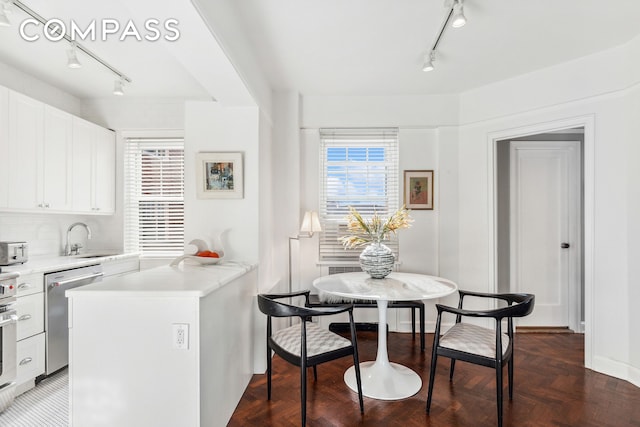 dining space featuring track lighting