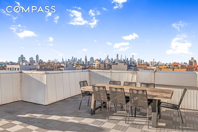 view of patio / terrace featuring a city view and outdoor dining space