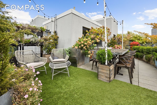 view of yard featuring outdoor dining space and fence